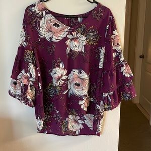 Gorgeous flows top with 3/4 layered sleeves and longer in the back than front.